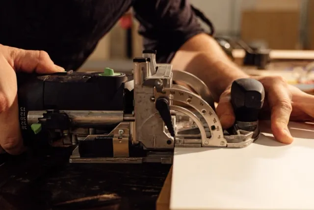 Festool domino tool close up for loose mortise and tenon joinery on plywood, hardwood, furniture, and cabinetry.