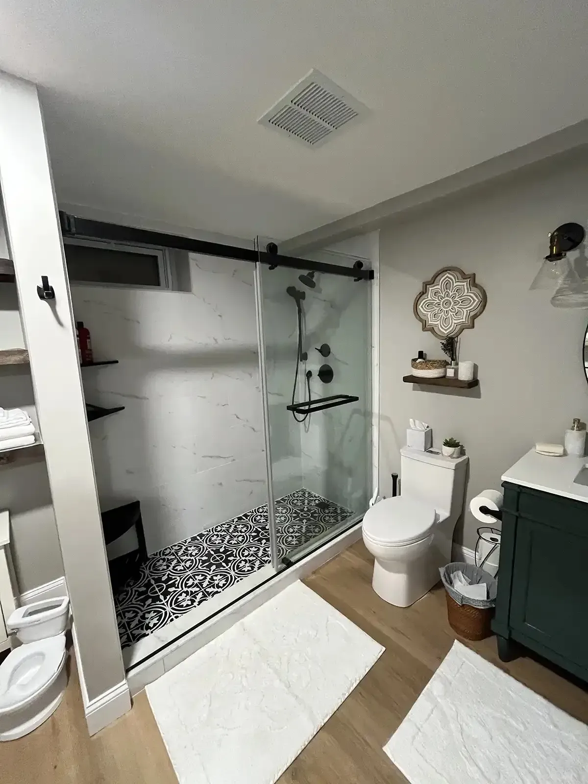 Basement bath with patterned shower pan and matte black fixtures