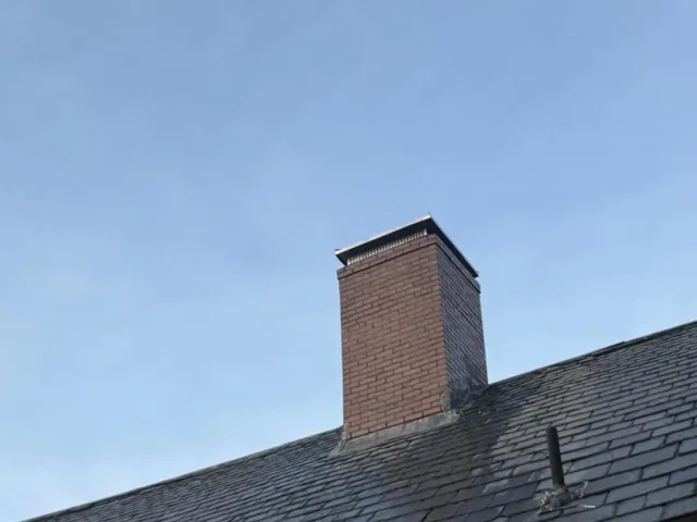 A rebuilt chimney stack finished with a new stainless cap