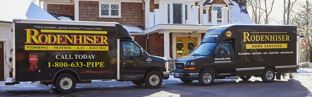 Branded Rodenhiser Home Services trucks parked at a residential job