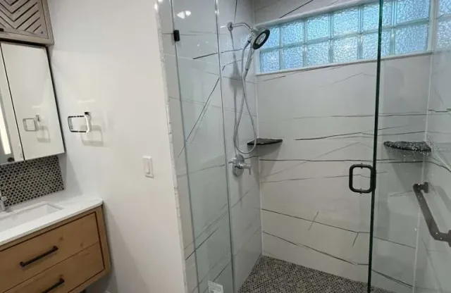 Newton MA master bathroom after Sun Shore remodel: modern vanity, walk-in shower, bright lighting