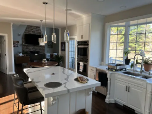 Repainted kitchen with white cabinetry and island