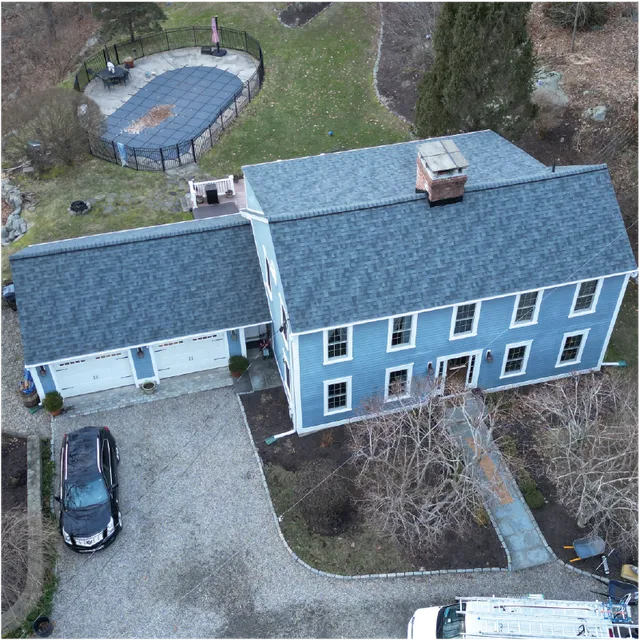 Storm-resistant shingle roof on blue colonial Connecticut home