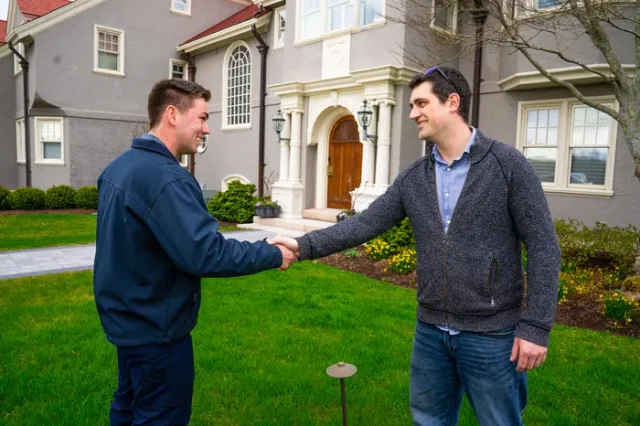 Seacoast Turf lawn care technician shaking hands with customer