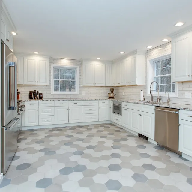 Large kitchen remodel with hexagon tile floors, custom cabinetry, undercabinet lights, and tile backsplash in Exeter, NH