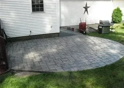 A patio with a grill and a star on the side of a house.