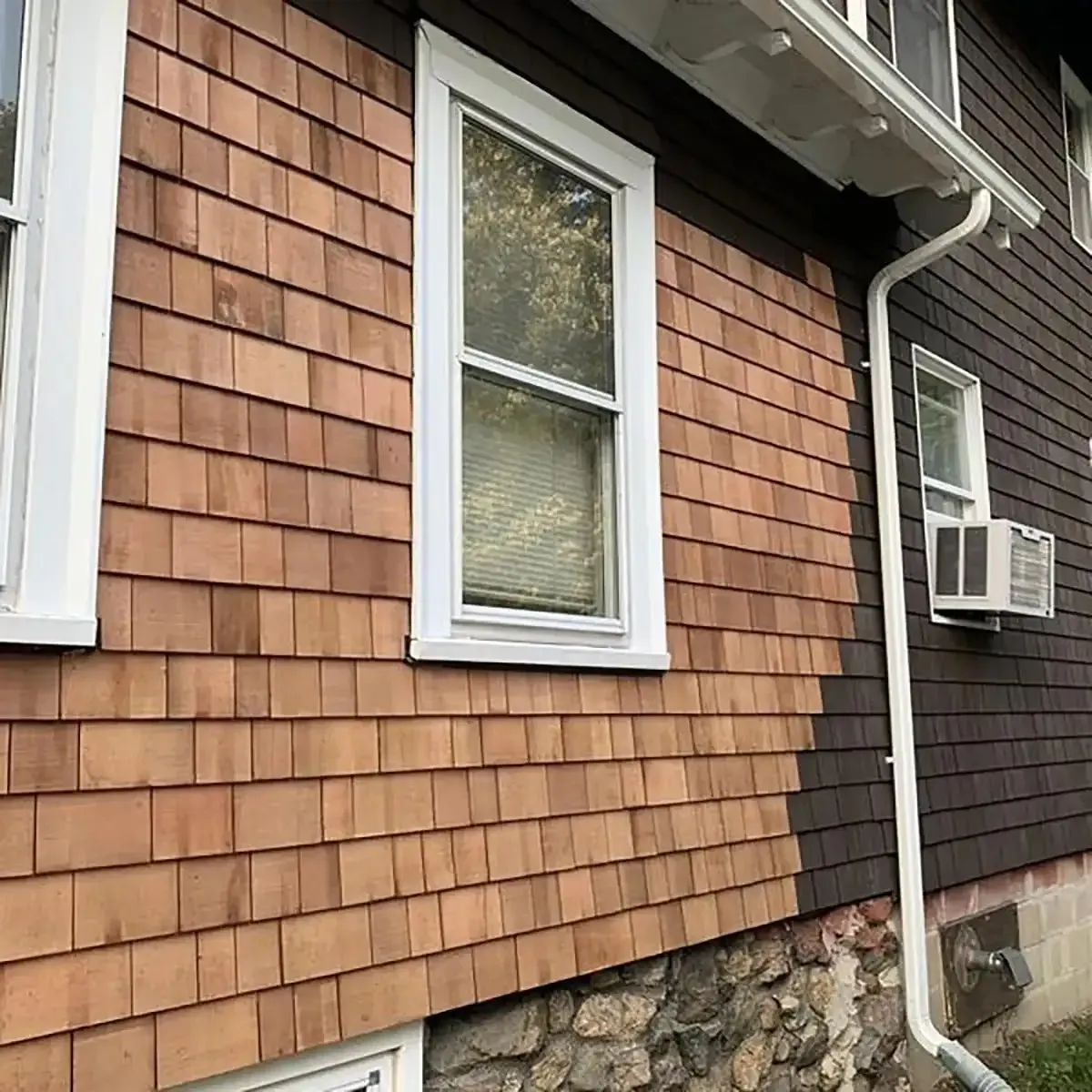 New cedar shingle siding going up over the original brown course