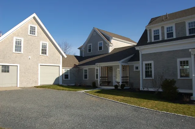 Driveway and renovated farmhouse with barn attached