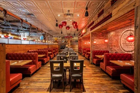Interior view of restaurant with red booths, Retail & Restaraunts, tables, and lighting.