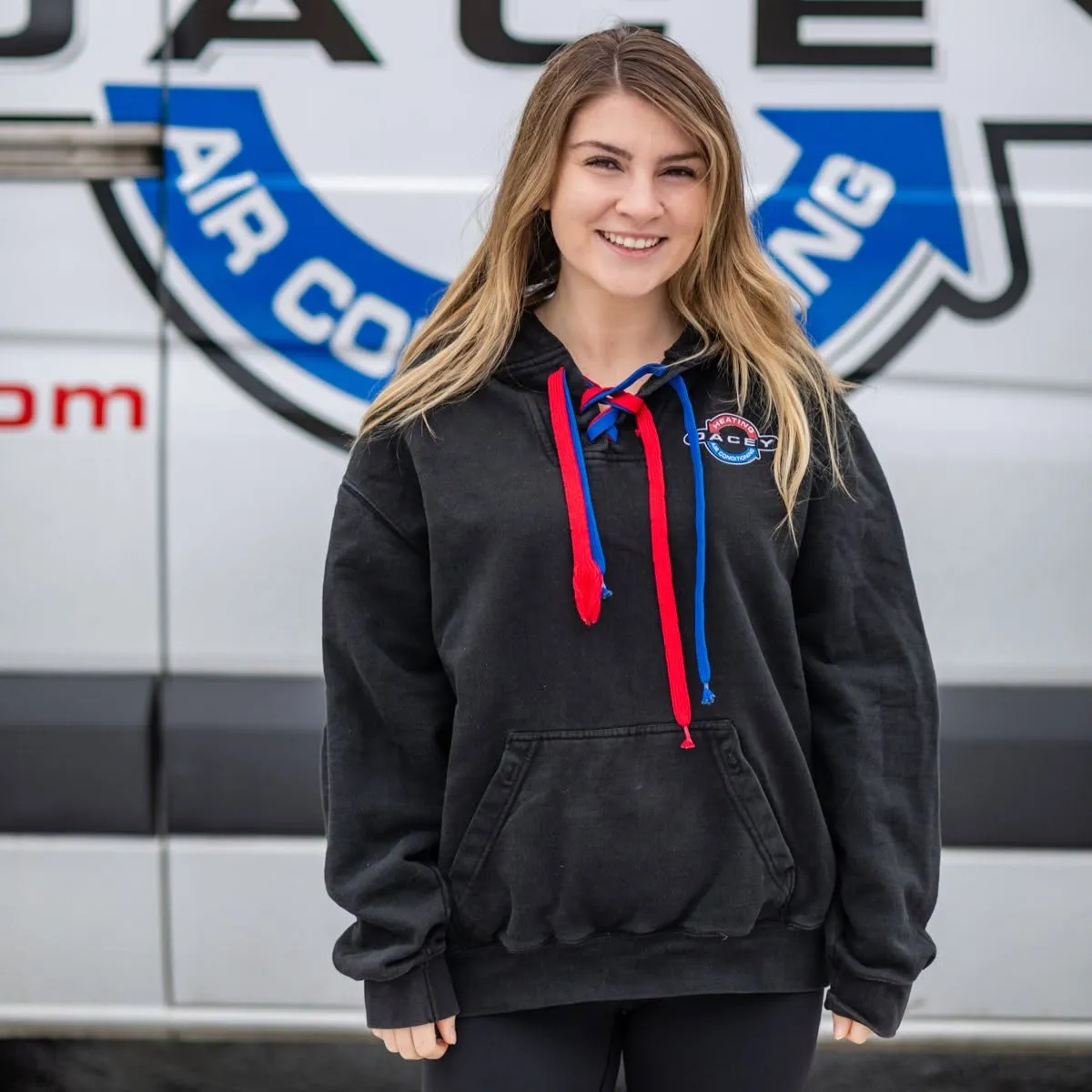 Dacey team member in branded workwear at the company van