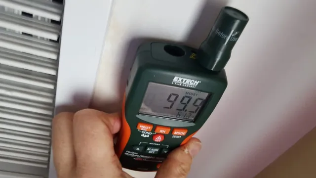 Moisture meter showing 99 percent reading at saturated HVAC vent