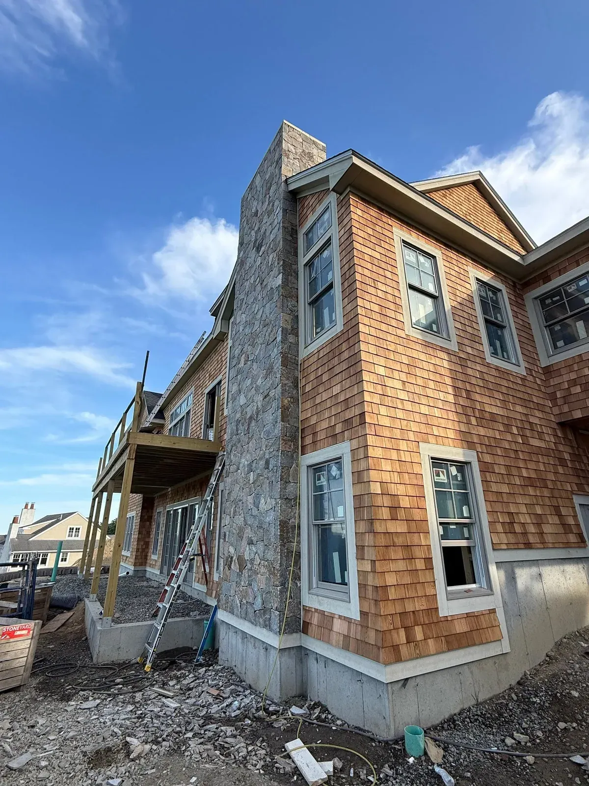 Natural stone veneer covering the exterior of a coastal home