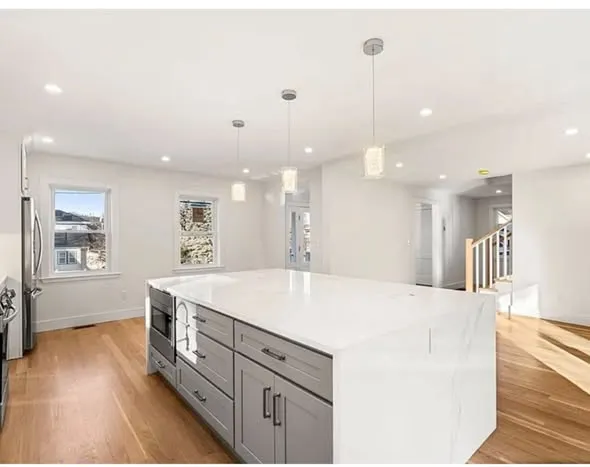 Finished kitchen with island and pendant lighting