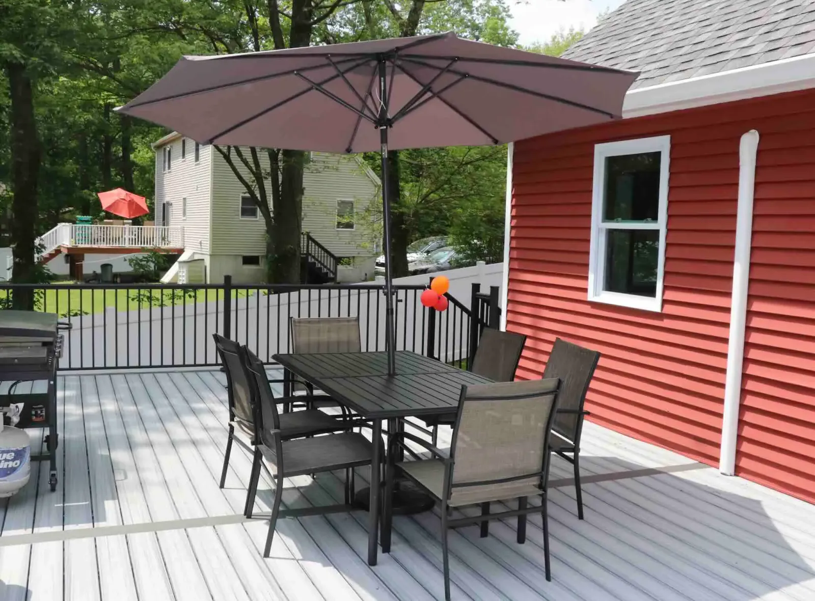 Residential decking with black aluminum railing with outdoor living furnitures and grills in worcester ma