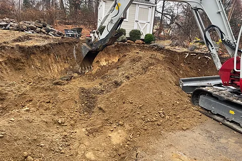 A mini excavator digging a hole