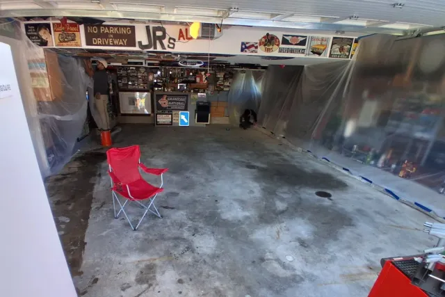 A Naugatuck garage before work: bare concrete with dark oil stains across the middle
