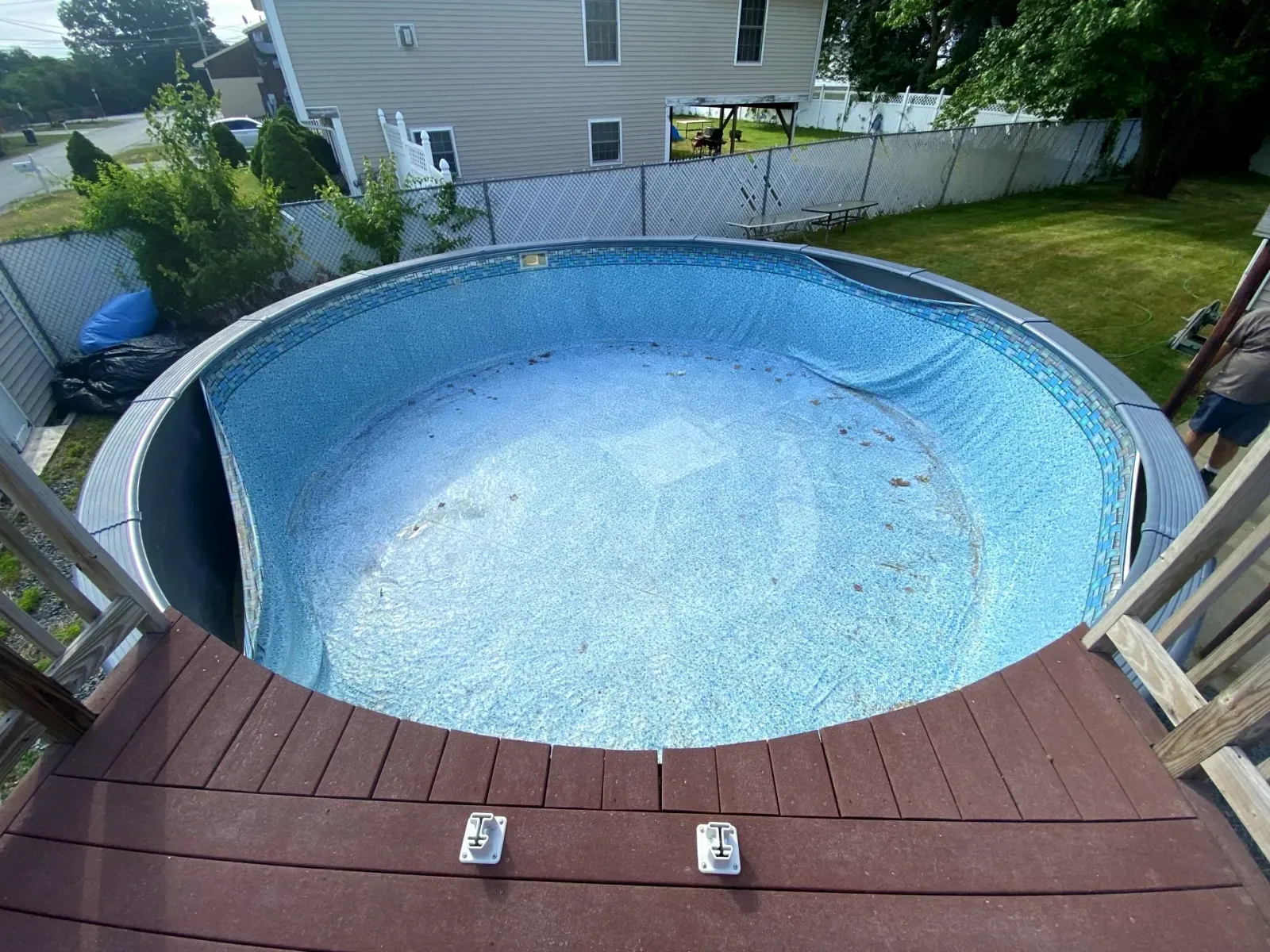 Above ground pool with torn and loose hanging pool liner