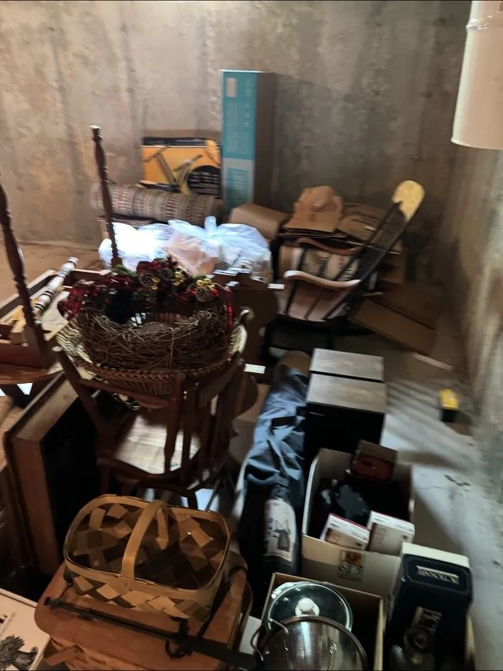 Same storage room before, filled with furniture, baskets and boxes