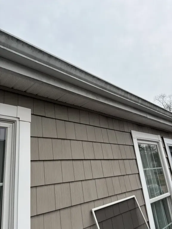 Dirty gutter exterior before professional cleaning service Hingham Massachusetts