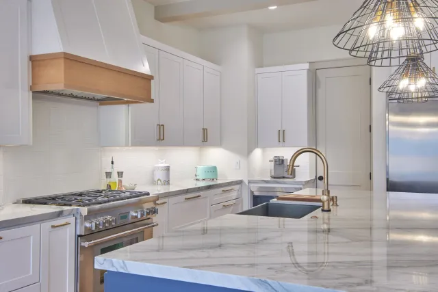 Modern White Kitchen with Brushed Gold Hardware and Quartz Countertop.jpeg