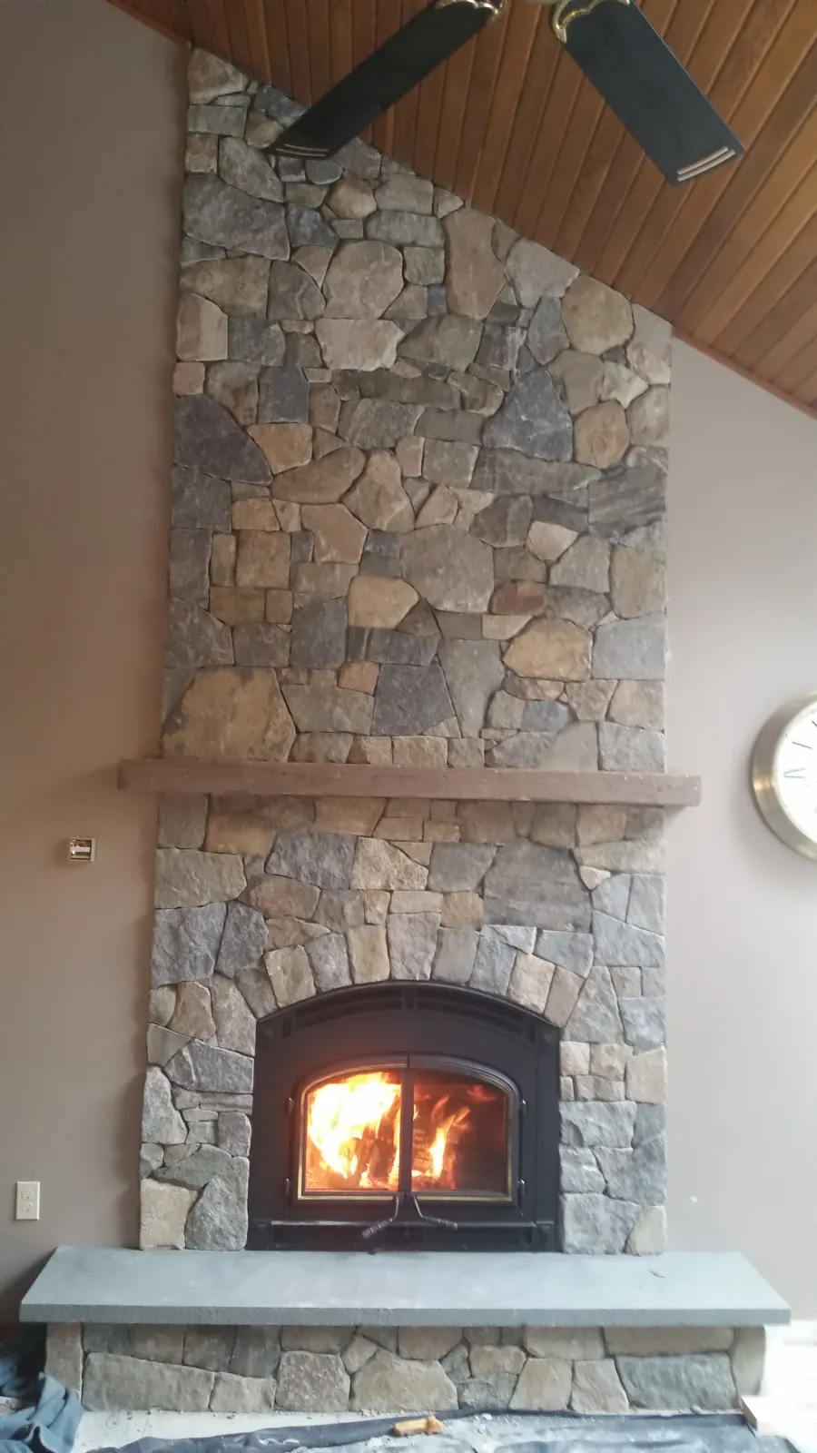 wood burning fireplace with natural stone