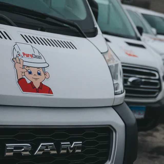 Fleet of white Valerio Plumbing service vans parked and ready for emergency dispatch.