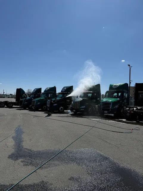 Full fleet of R+L Carriers trucks being pressure washed on-site by Sunset