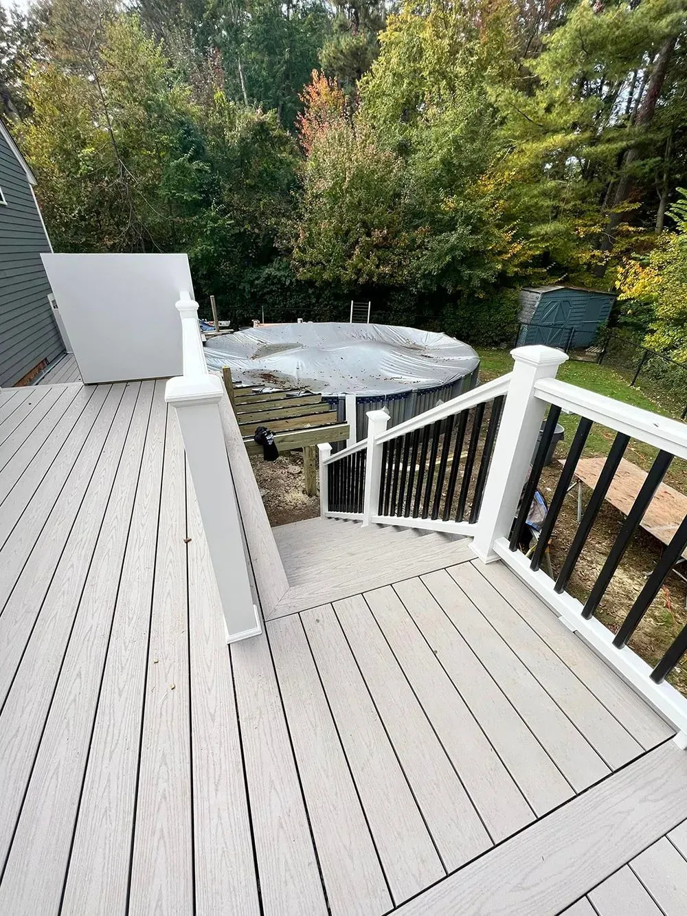 A deck with stairs leading up to a pool