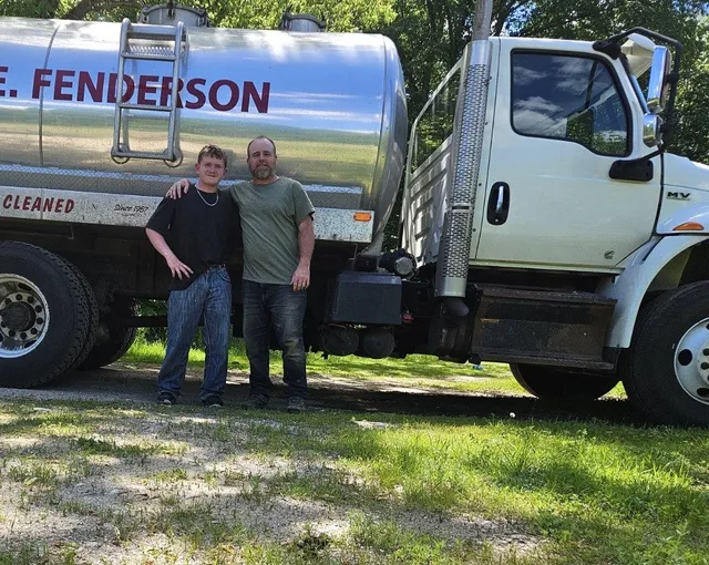 Jason and his son beside the W.E. Fenderson septic pumping truck