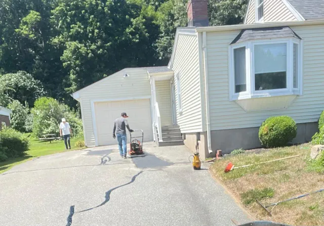 Hermans Paving & Asphalt team paving an asphalt driveway in Massachusetts