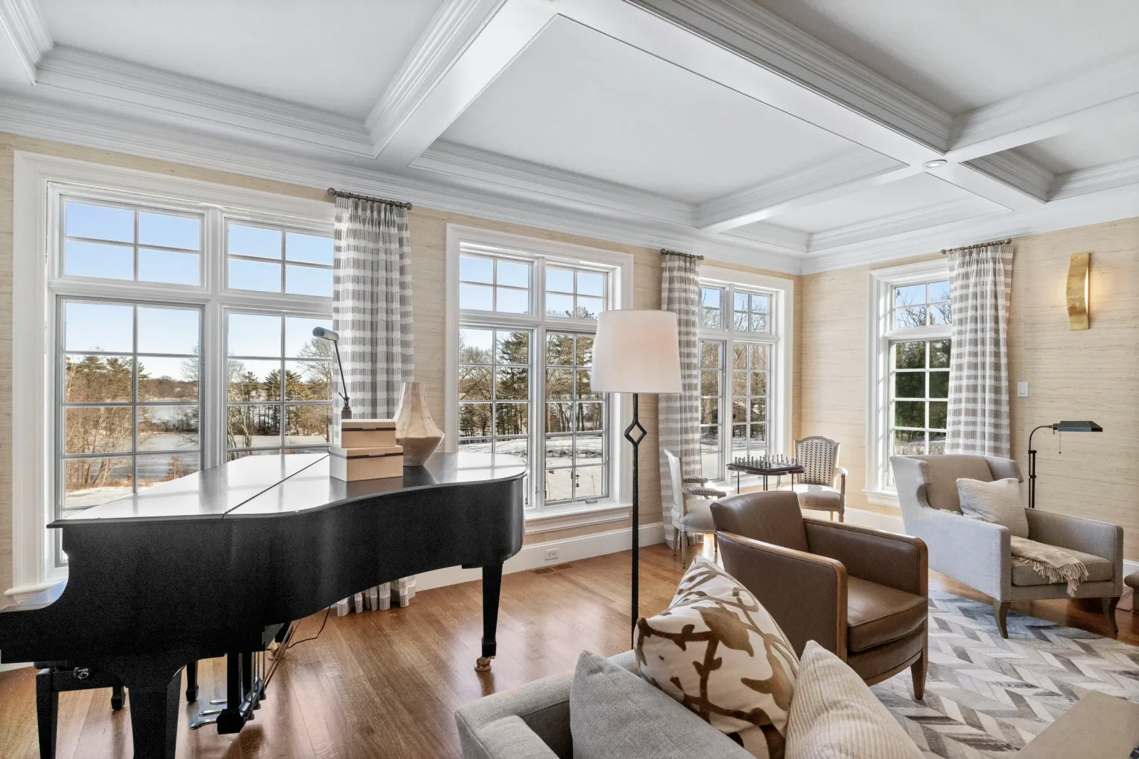 Warm and inviting formal living room with baby grand piano in Walpole custom home