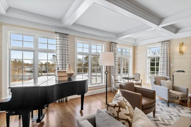 Warm and inviting formal living room with baby grand piano in Walpole custom home