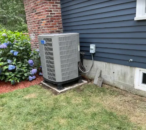 Outdoor HVAC condenser installed beside a home