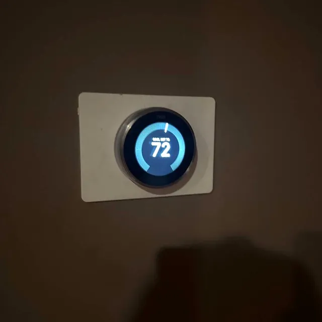 Newly installed smart thermostat on the wall
