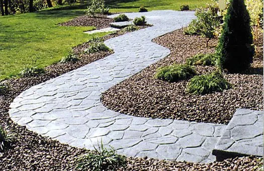 Curved flagstone-pattern concrete garden walkway