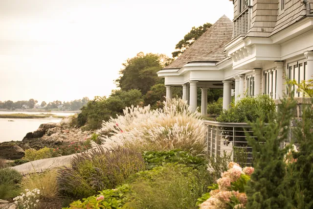 Ornamental grasses and perennial borders along a shingle-style residence