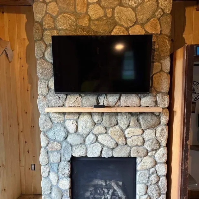 Fieldstone fireplace surround built by the crew