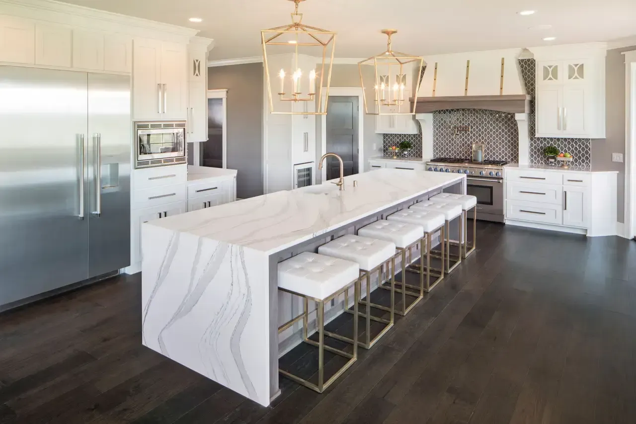 Cambria Brittanicca quartz kitchen island with seating and pendant lighting