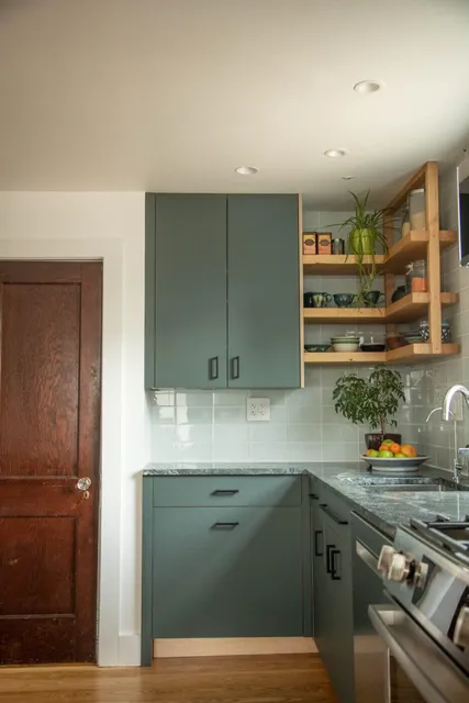 Plywood cabinetry with green laminate fronts in Northampton, Massachusetts.