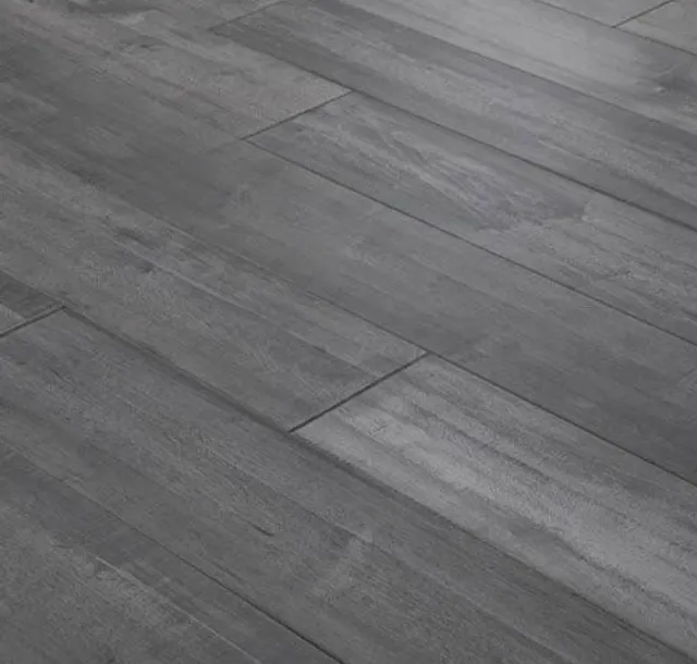 Close-up of gray wooden floorboards with visible grain and seams.