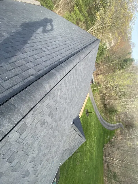 side view of bluish gray roof showing the road