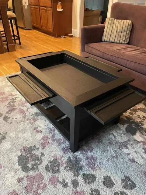 Custom black wood coffee table with sliding trays and storage in a Central Connecticut home by Riverbend Renovations