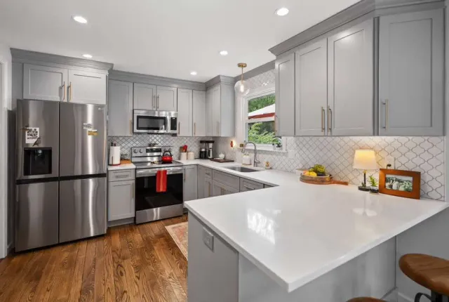 gray and white kitchen with large peninsula countertop