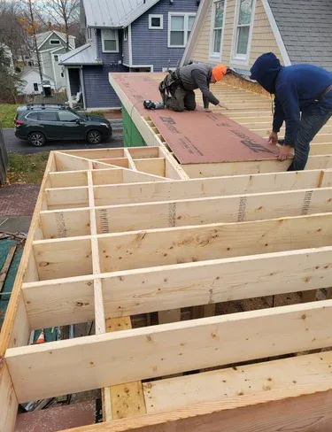 A man working on a new construction deck