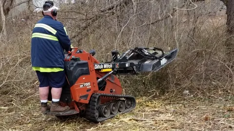 Using a mini skid steer to mow brush