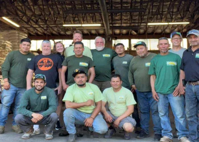 Work crew in green shirts posing