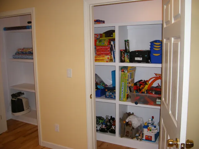 Built-in storage and shelving carpentry in a finished basement