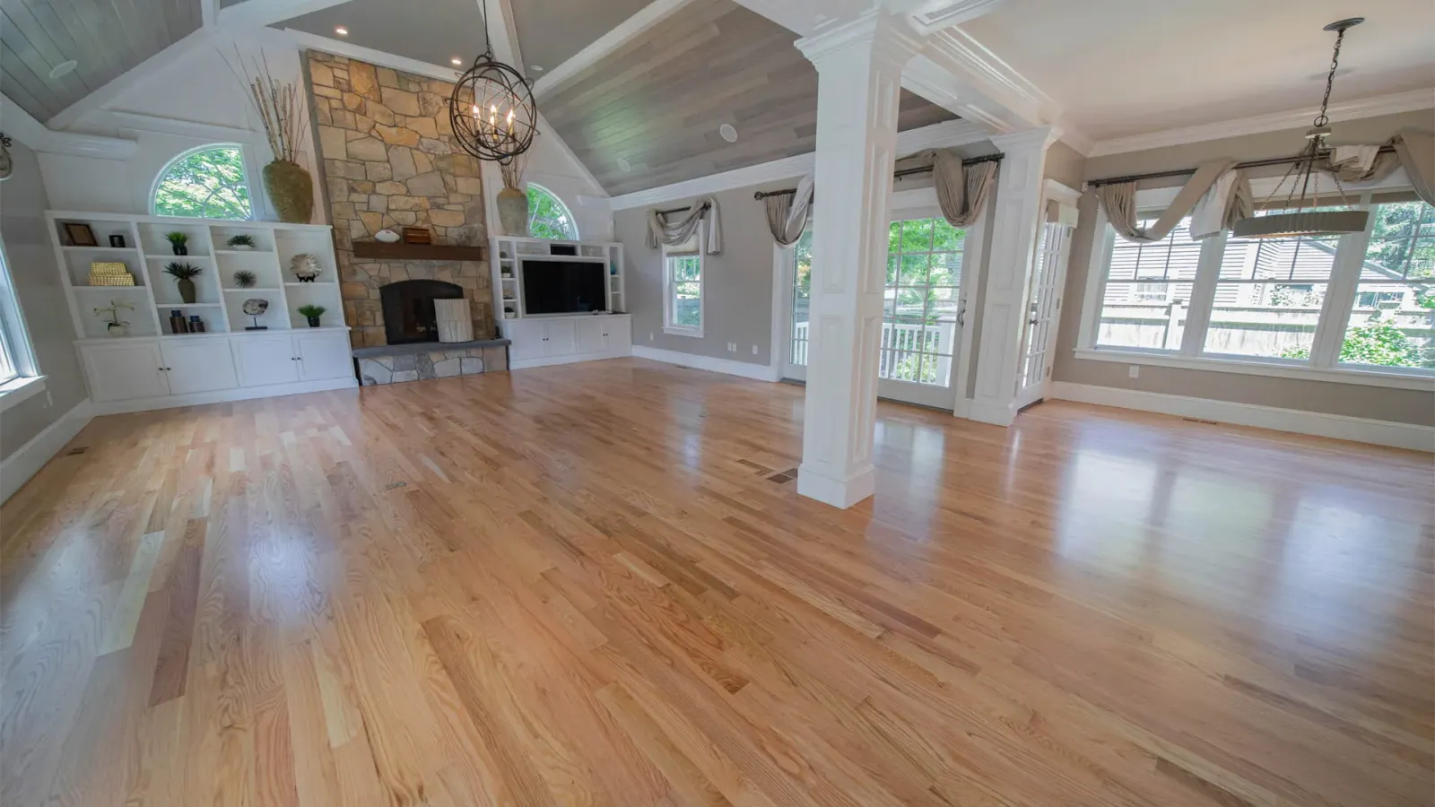 Refinished hardwood floor in a bright living room