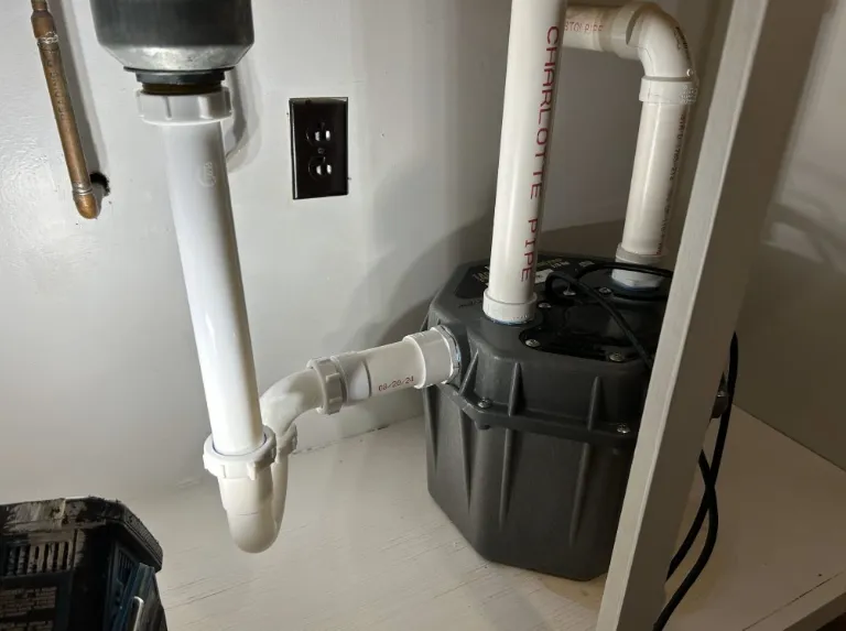 pipes under a sink highlighting a pipe repair job done by Flow Pro Plumbing and Drain Cleaning