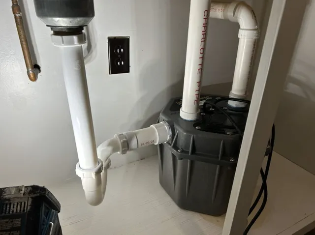 pipes under a sink highlighting a pipe repair job done by Flow Pro Plumbing and Drain Cleaning